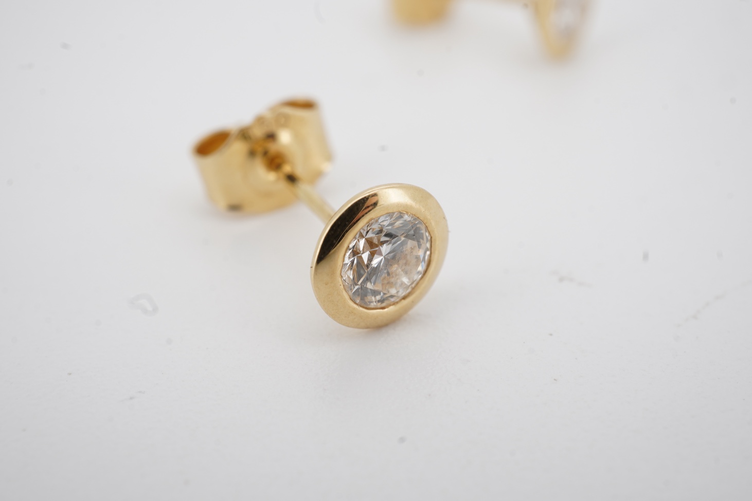 A pair of 18k and solitaire diamond set ear studs, each stone weighing approximately 0.25ct, gross weight 1.5 grams.